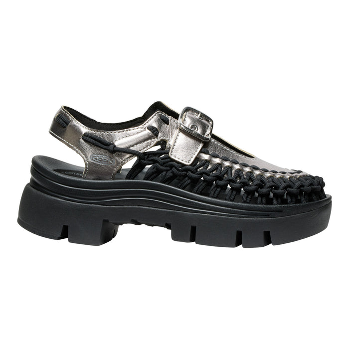 Black sandal with metallic buckle on a white background