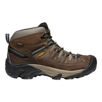 Brown hiking boot with black sole on a white background