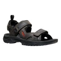 Black sandal with a visible brand logo on a white background