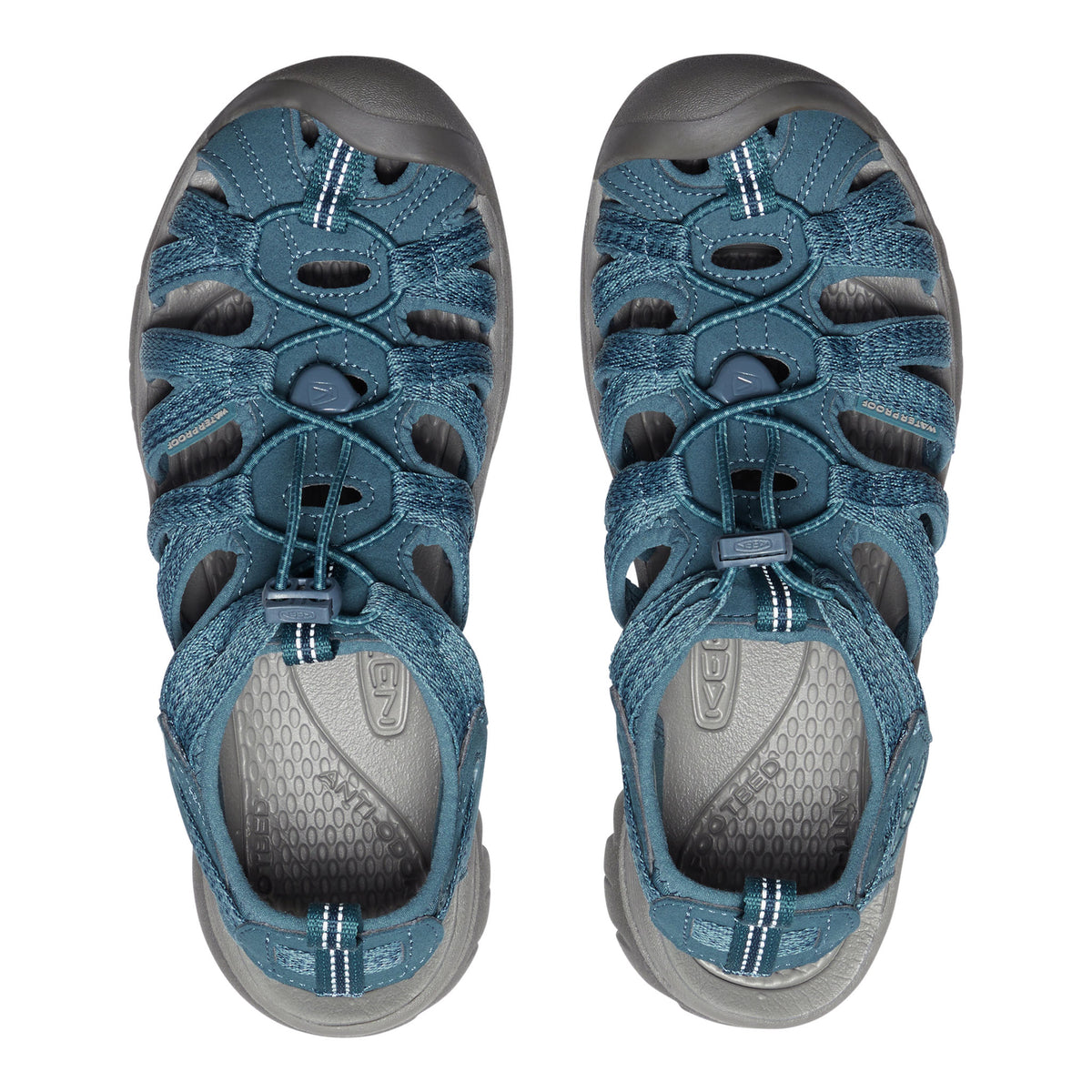 Pair of blue sandals with gray soles on a white background