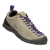 A Keen hiking shoe in light taupe suede with purple laces, black heel and toe accents, and a black pull tab, shown on a plain white background.
