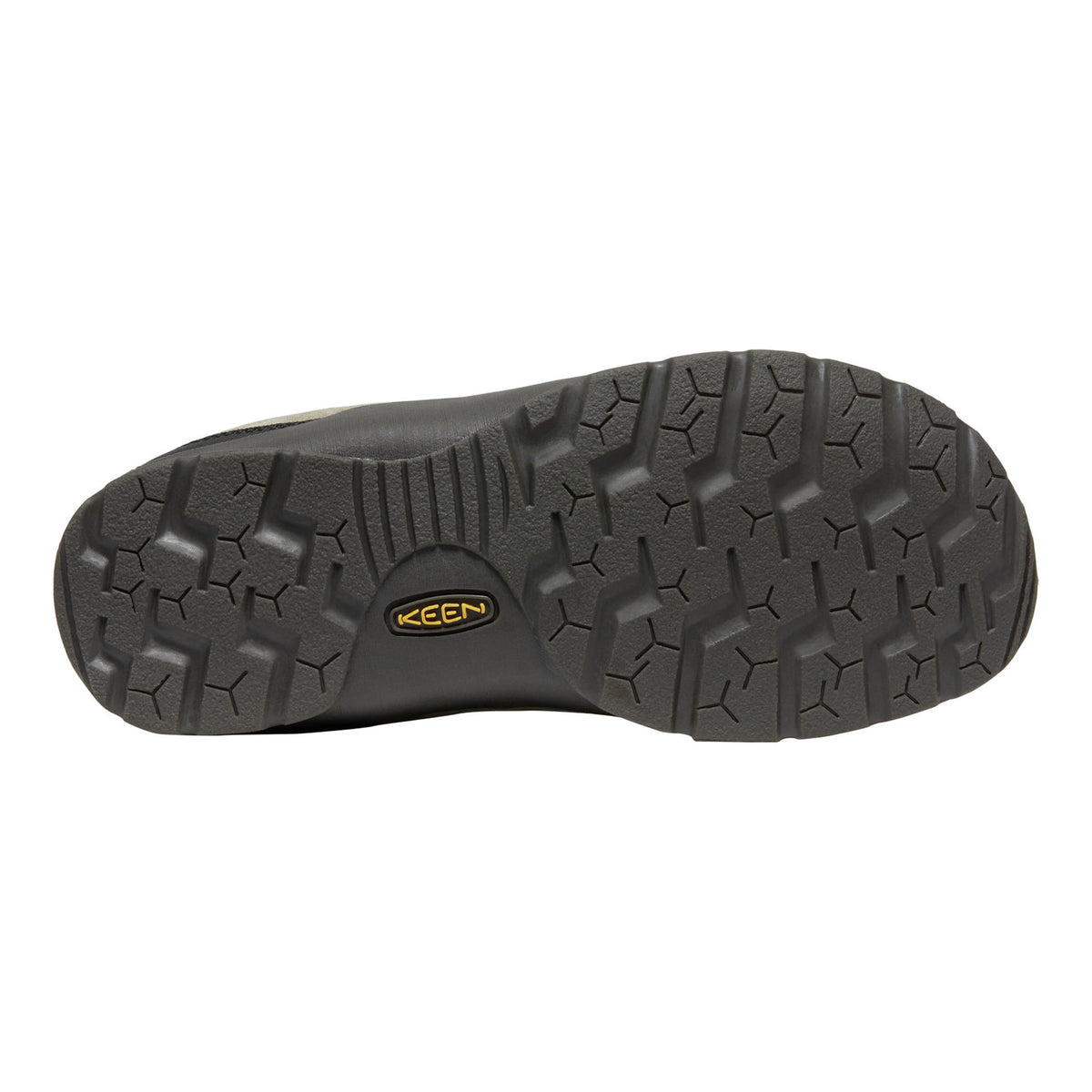 The treaded black rubber outsole of a Keen shoe, featuring a yellow and black Keen logo in the center, shown against a plain white background.