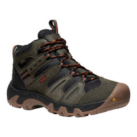Green hiking boot with brown sole on a white background