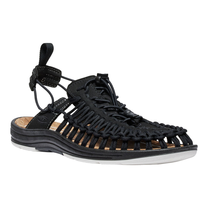 Black sandal with woven design on a white background