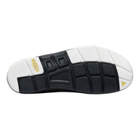 Close-up of a shoe sole with white and black design on a white background