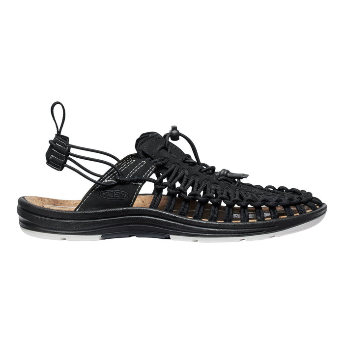 Black sandal with unique sole design on a white background