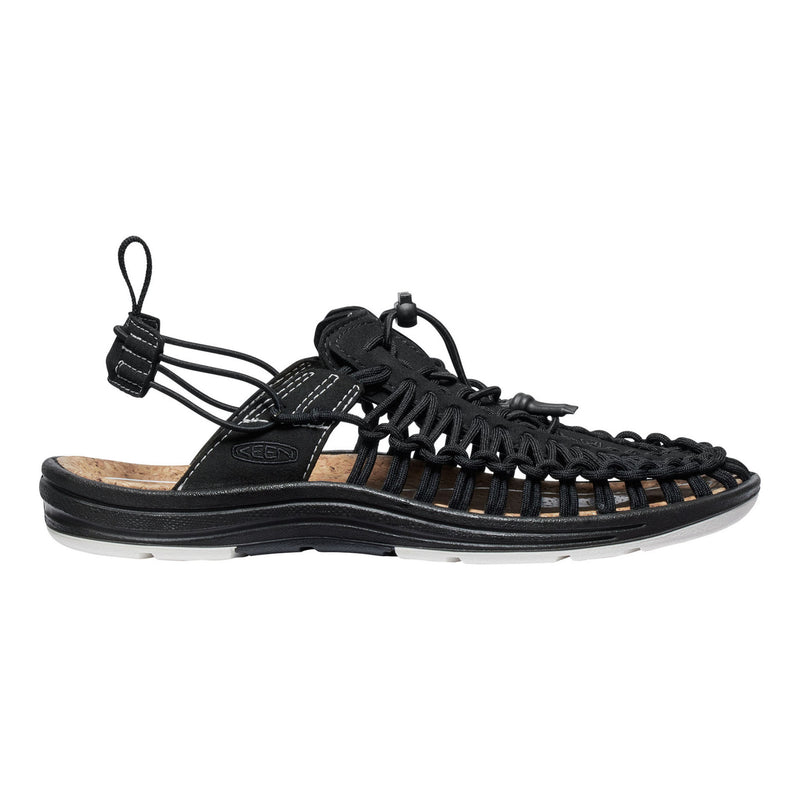Black sandal with unique sole design on a white background