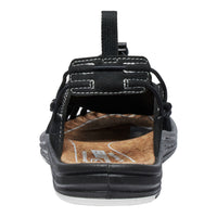 Black sandal with a brown insole on a white background