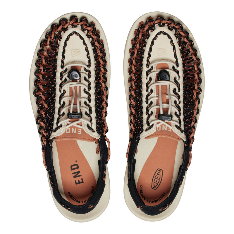 Pair of Keen sandals with braided design on a white background