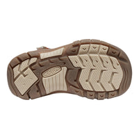 A top-down view of a Keen sandal's textured brown and beige outsole, showing the brand logo embossed in the center tread, set against a plain white background.