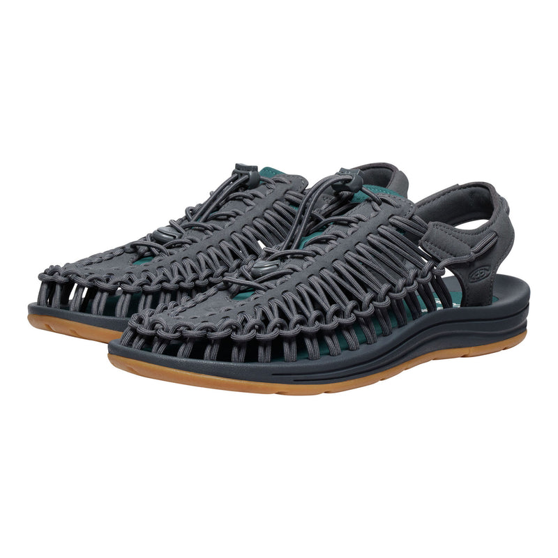 Pair of gray sandals with brown soles on a white background