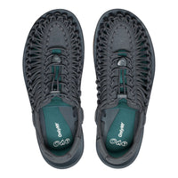 Pair of gray and green shoes with unique sole design on a white background