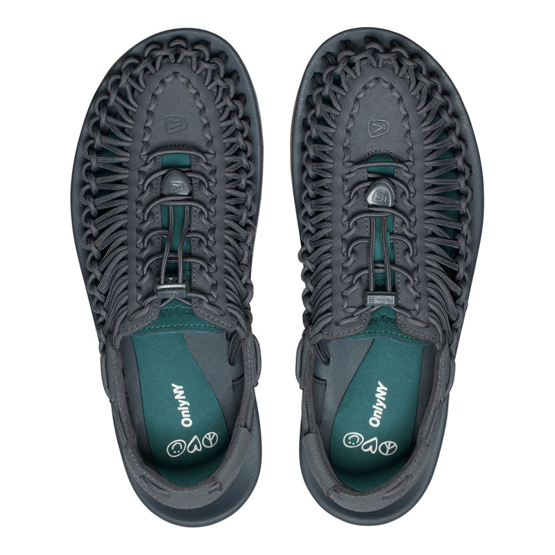 Pair of gray and green shoes with unique sole design on a white background