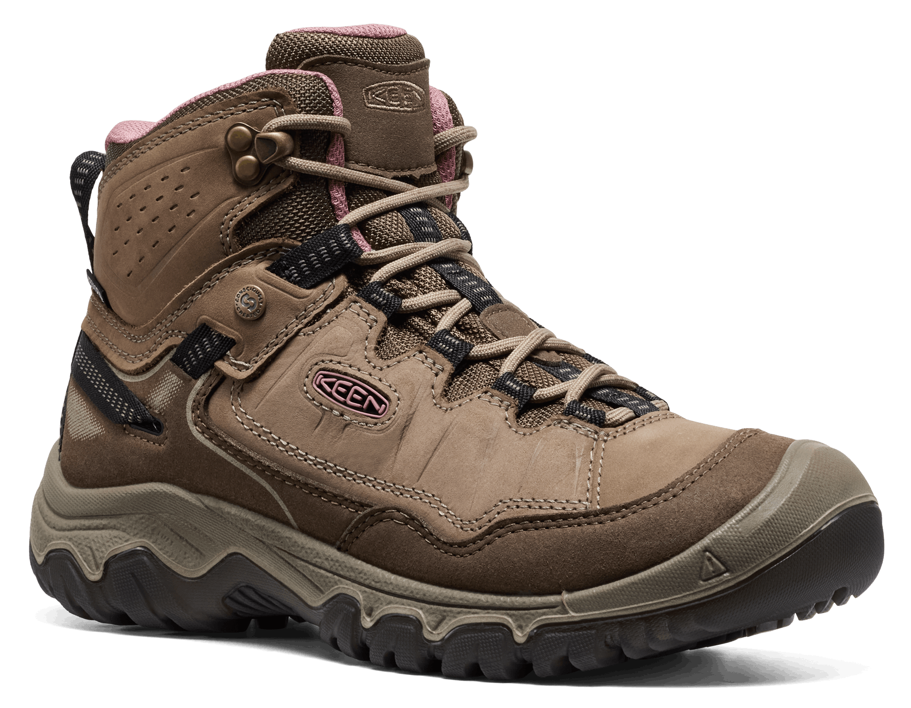 A Keen mid-cut hiking boot in brown suede and synthetic materials, featuring a pink inner collar lining, beige laces, and a rugged black and gray outsole, shown on a white background.