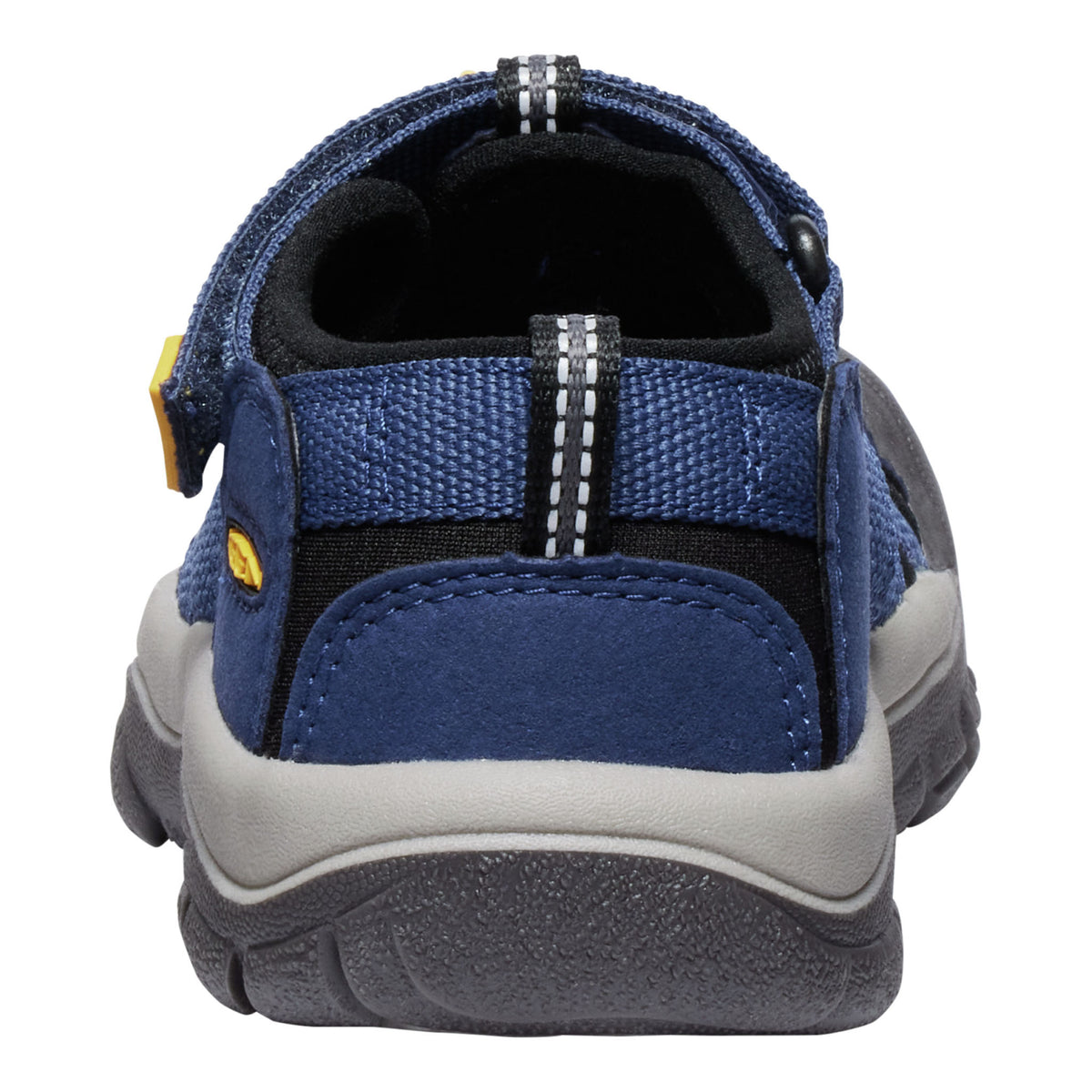 A close-up rear view of a blue and gray slip-on shoe with a textured fabric upper, black lining, and a gray and black sole, shown on a white background.