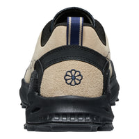 Back view of a black and beige shoe with a brand logo on a white background