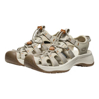 Pair of beige and brown sandals on a white background