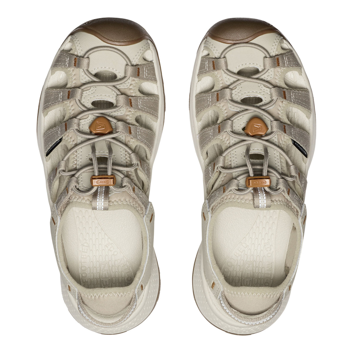 Pair of beige hiking sandals with brown accents on a white background
