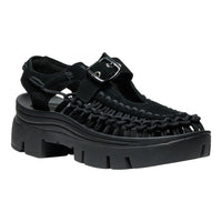 Black sandal with thick sole on a white background