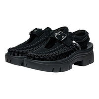 Black woven sandals with thick soles on a white background