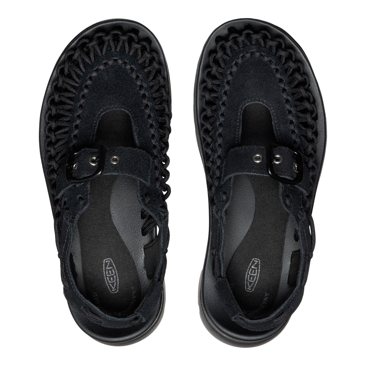 Black sandals with woven design on a white background