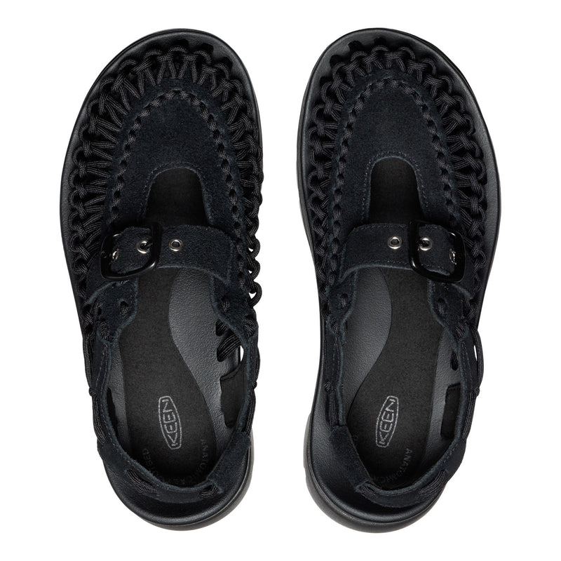 Black sandals with woven design on a white background