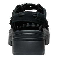 Black sandal with thick sole on a white background