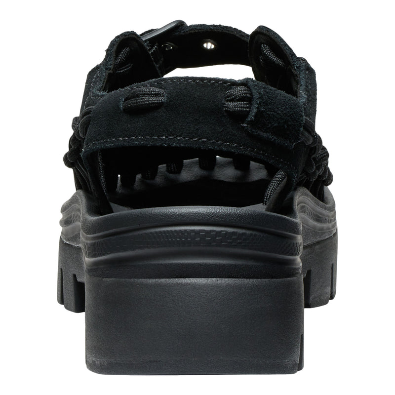 Black sandal with thick sole on a white background