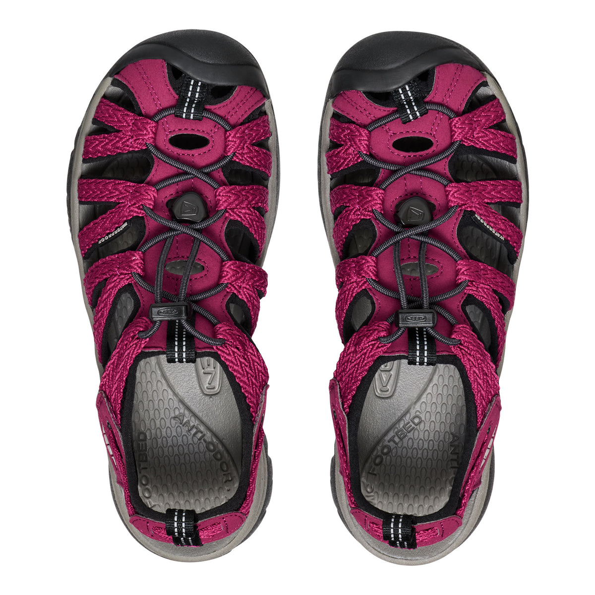 Pair of pink and black sandals on a white background