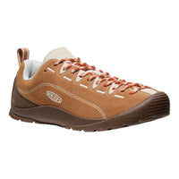 Brown sneaker with orange laces on a white background