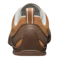 Brown and white shoe with a visible sole on a white background
