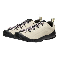 Pair of beige and black hiking shoes on a white background