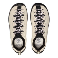 Pair of white sneakers with black accents and laces on a white background