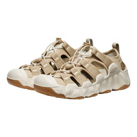 A pair of KEEN brand midfoot lace-up sandals in beige and off-white, shown from a three-quarters angle against a plain white background.