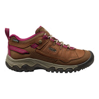 A single Keen hiking boot in brown leather with vibrant pink accents, beige laces, and a gray and black sole, shown in a side profile on a white background.