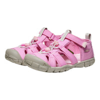 Pink children's sandals with gray soles on a white background