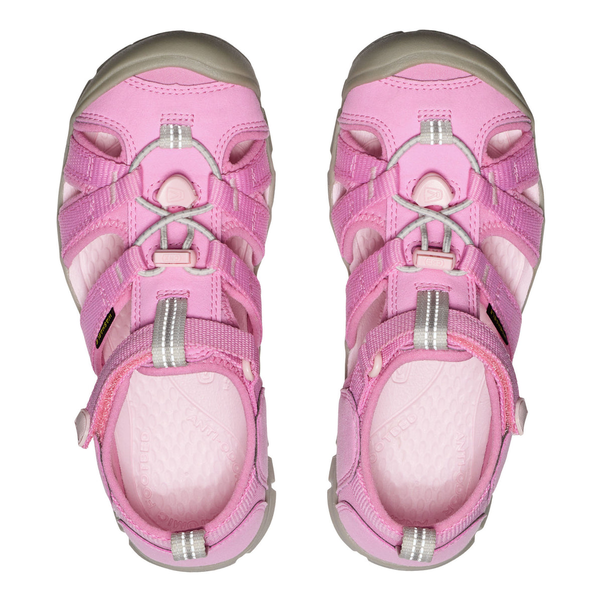 Pair of pink children's sandals on a white background