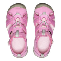 Pair of pink children's sandals on a white background