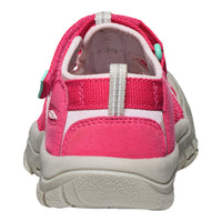 Pink children's sandal with a white sole on a white background