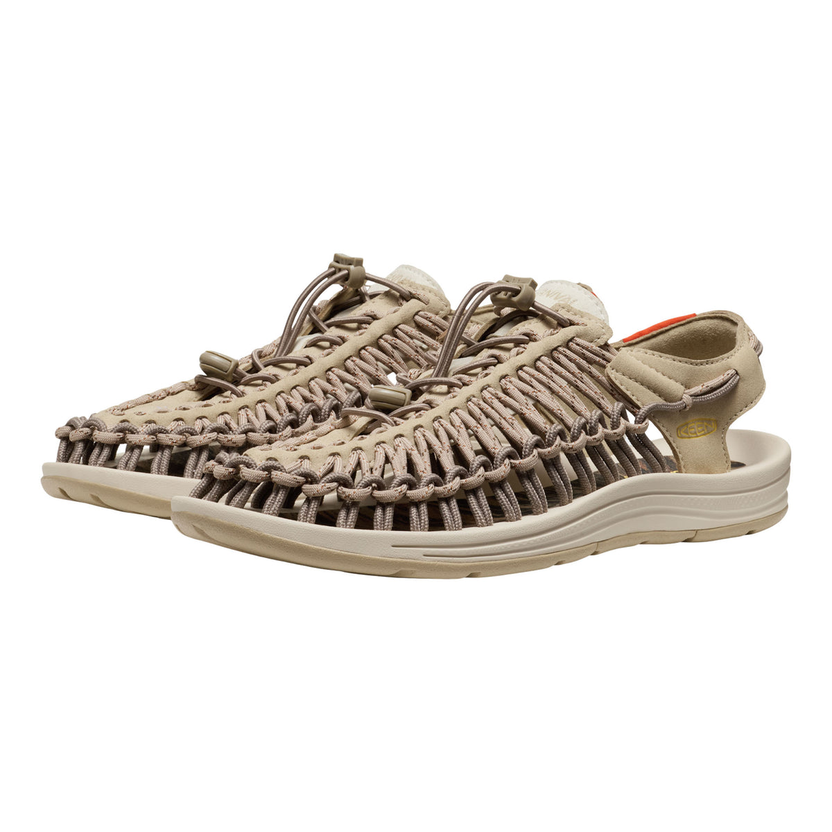 Beige sandals with woven design on a white background