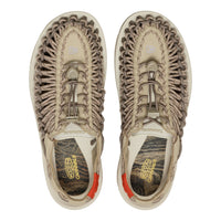 Pair of beige and brown sneakers with braided design on a white background