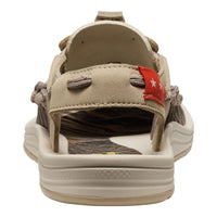Beige sandal with a red flag label on a white background