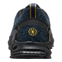 Back view of a blue and black shoe with a yellow logo on a white background