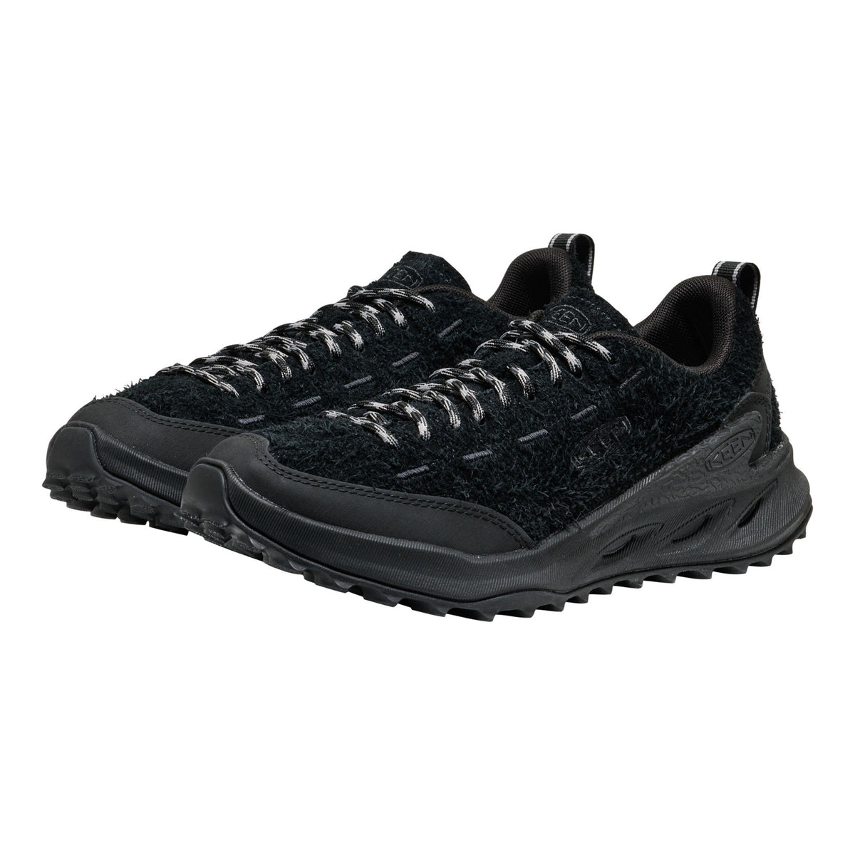 A pair of black trail running shoes with textured knit uppers, black laces, and rugged black soles, shown against a plain white background.