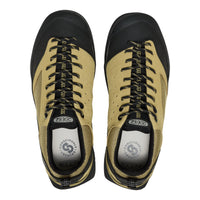 Pair of beige and black KEEN shoes on a white background