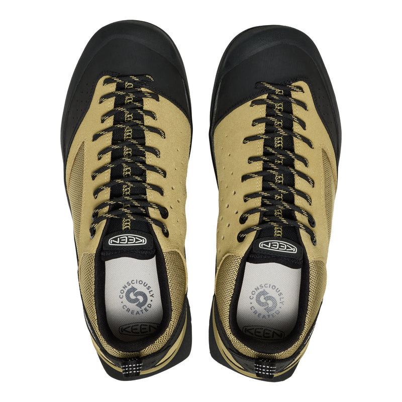 Pair of beige and black KEEN shoes on a white background