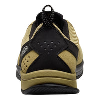 Black and beige sneaker with a visible brand logo on a white background