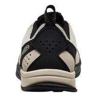 Black and beige athletic shoe on a white background