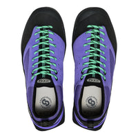Purple sneakers with green laces on a white background