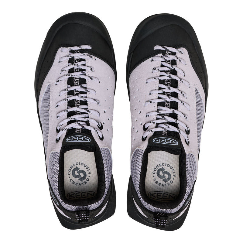 Pair of black and white KEEN shoes on a white background